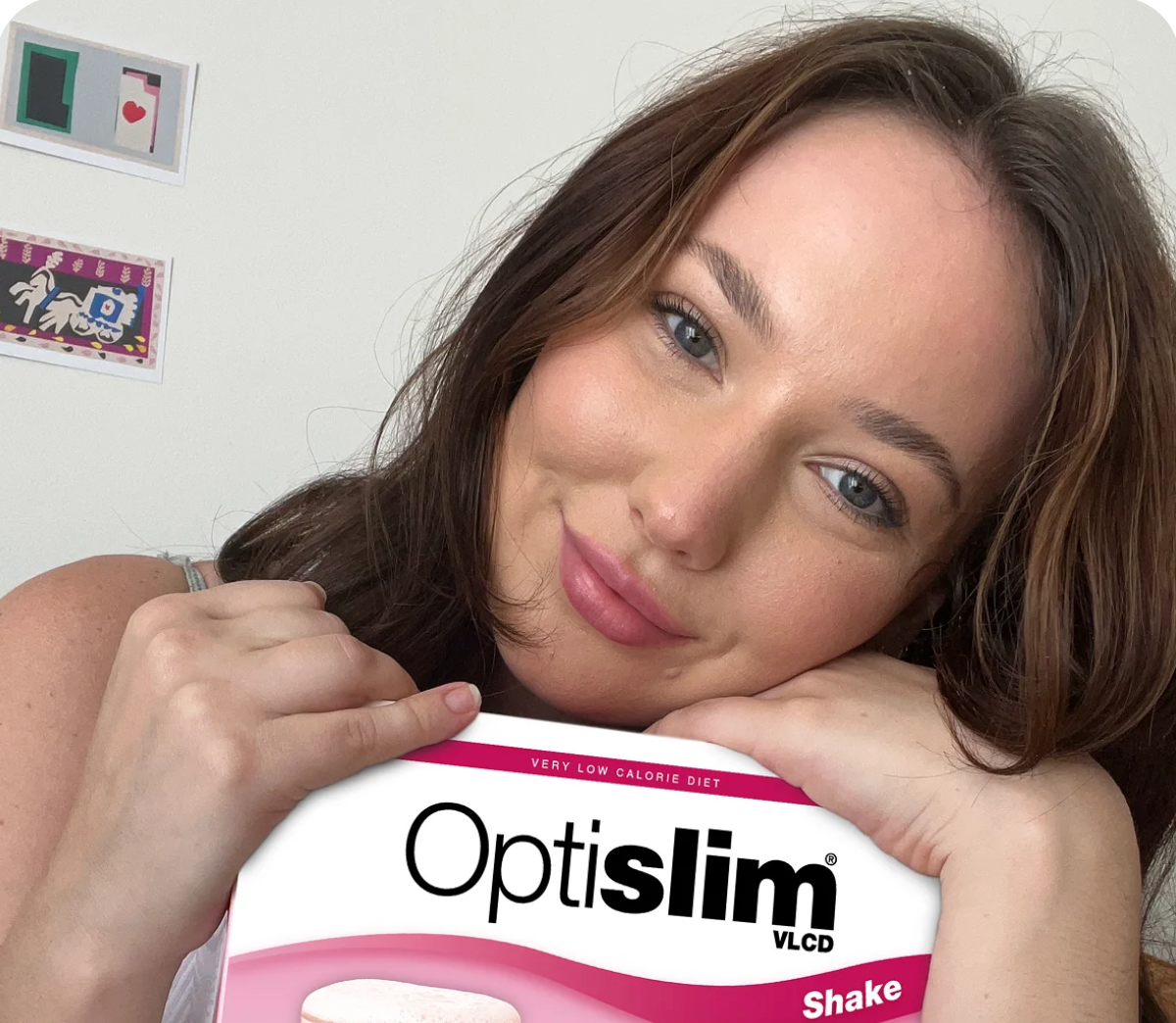 Optislim customer holding a box of Strawberry VLCD Shakes
